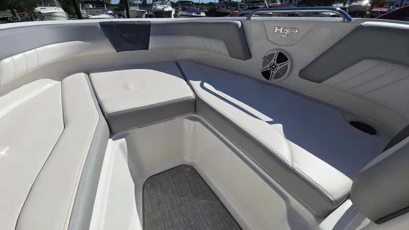 Slide: The Image of 2019 Chaparral 21 H2O Sport boat interior with cushioned seating and speaker. - 25