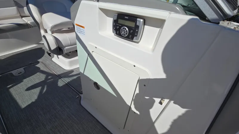 Slide: The Image of 2019 Chaparral 21 H2O Sport boat interior with control panel and seating. - 28
