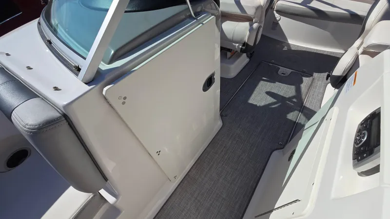 Slide: The Image of 2019 Chaparral 21 H2O Sport boat interior with seating and carpeted flooring. - 29
