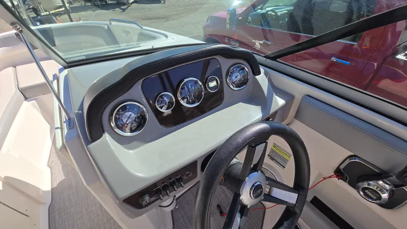 Slide: The Image of 2019 Chaparral 21 H2O Sport dashboard with steering wheel and gauges. - 32