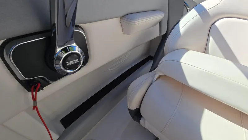 Slide: The Image of 2019 Chaparral 21 H2O Sport interior with white seating and speaker detail. - 33