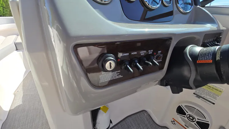 Slide: The Image of Control panel of a 2019 Chaparral 21 H2O Sport boat with switches and ignition. - 35