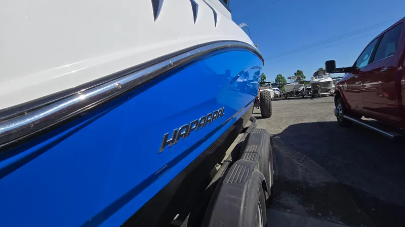 Slide: The Image of 2019 Chaparral 21 H2O Sport boat on trailer, blue and white design. - 4