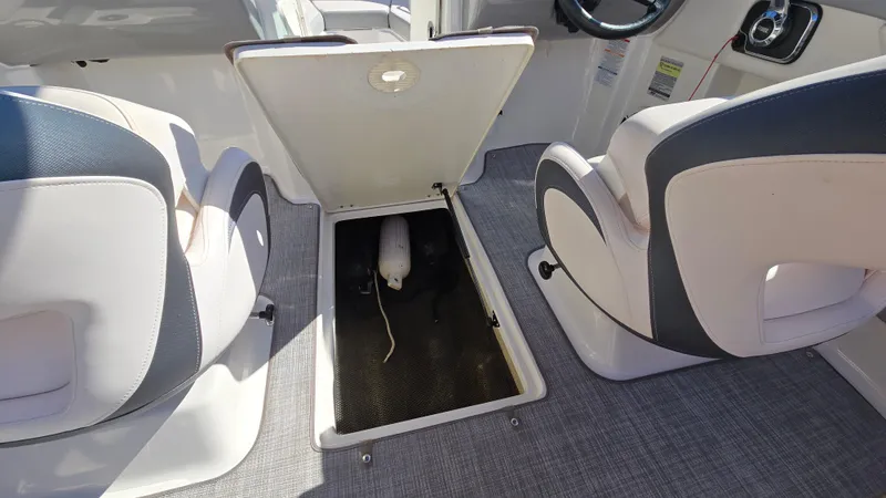 Slide: The Image of 2019 Chaparral 21 H2O Sport boat interior with open storage compartment. - 40