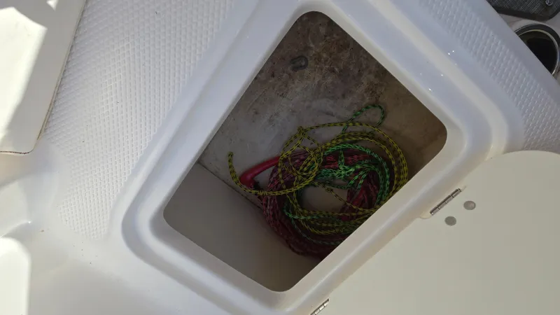 Slide: The Image of Storage compartment with ropes in a 2019 Chaparral 21 H2O Sport boat. - 43