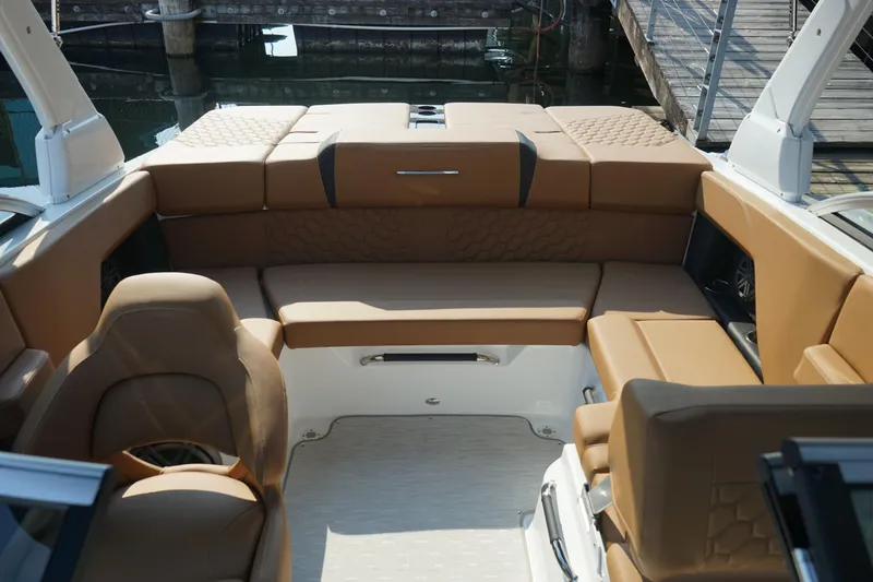 Slide: The Image of 2023 Four Winns H2 Surf boat interior with tan seating and modern design. - 11