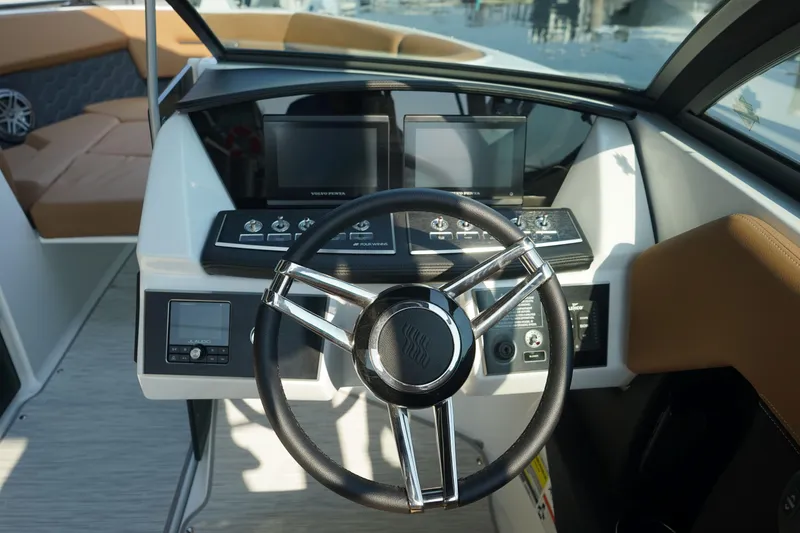 Slide: The Image of 2023 Four Winns H2 Surf boat dashboard with modern steering and digital displays. - 16