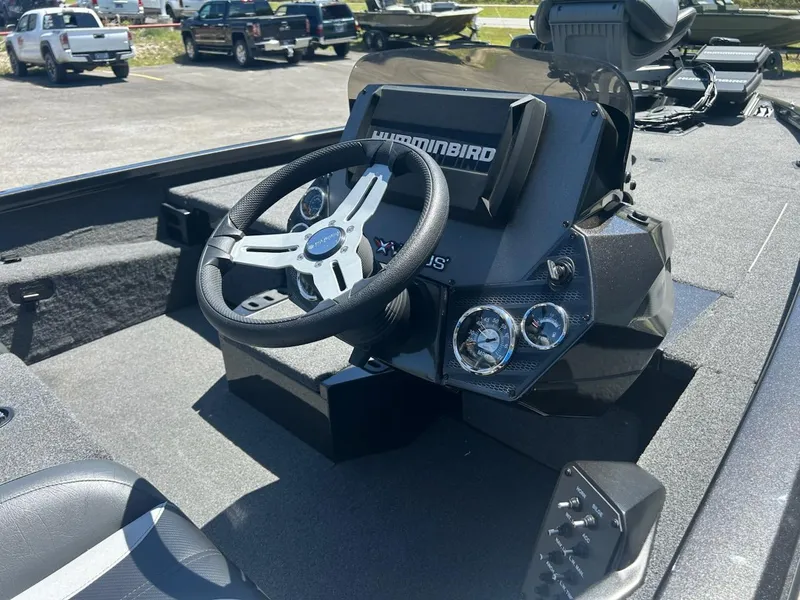 Slide: The Image of 2022 Vexus AVX1880 boat dashboard with steering wheel and Humminbird electronics. - 11