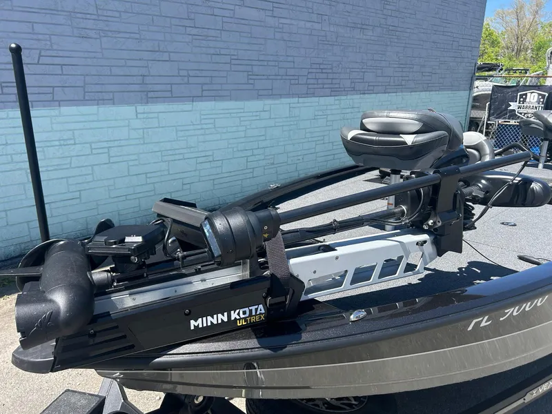 Slide: The Image of 2022 Vexus AVX1880 boat with Minn Kota Ultrex trolling motor, parked outdoors. - 9