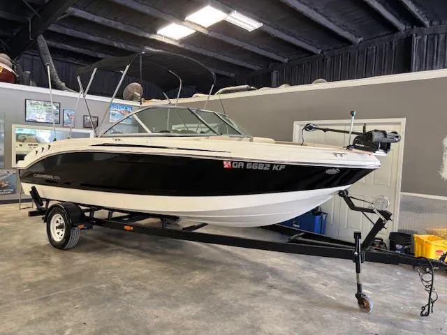 Slide: The Image of 2013 Chaparral 19 H2O Ski & Fish boat on trailer in indoor storage. - 1