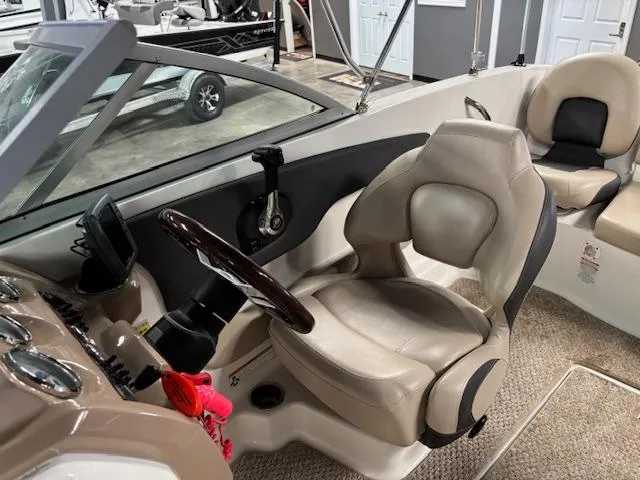 Slide: The Image of 2013 Chaparral 19 H2O Ski & Fish boat interior with beige seating and steering wheel. - 12