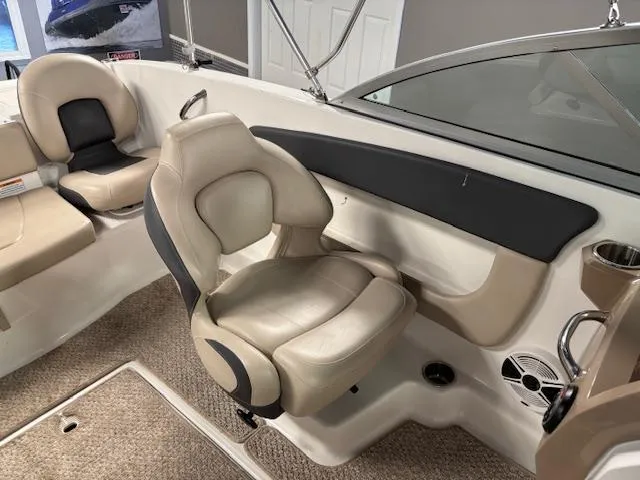 Slide: The Image of 2013 Chaparral 19 H2O Ski & Fish boat interior with beige seating and carpeted flooring. - 13