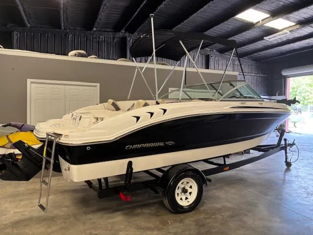 Slide: The Image of 2013 Chaparral 19 H2O Ski & Fish boat on trailer in indoor storage. - 2