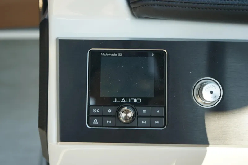Slide: The Image of JL Audio control panel on 2023 Four Winns H2 Surf boat dashboard. - 17