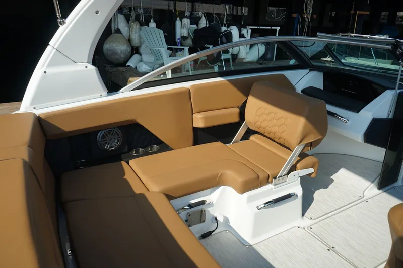 Slide: The Image of 2023 Four Winns H2 Surf boat interior with tan seating and modern design. - 18