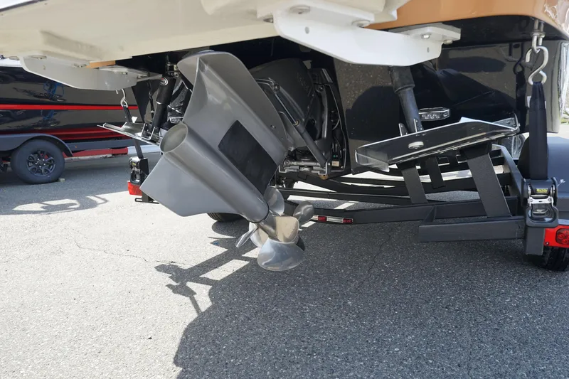 Slide: The Image of 2023 Four Winns H2 Surf boat propeller and stern view on trailer. - 24