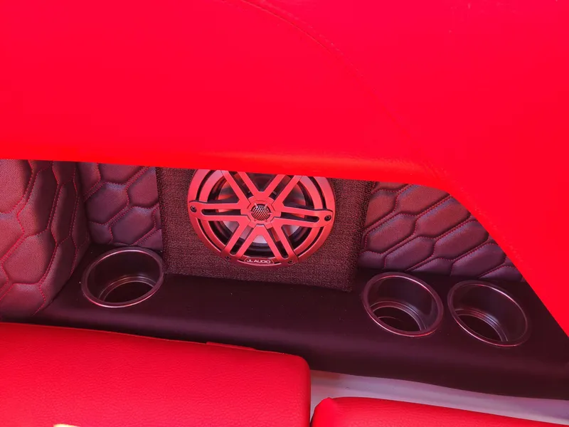 Slide: The Image of Red interior of 2023 Four Winns H2 Surf boat with speaker and cup holders. - 11