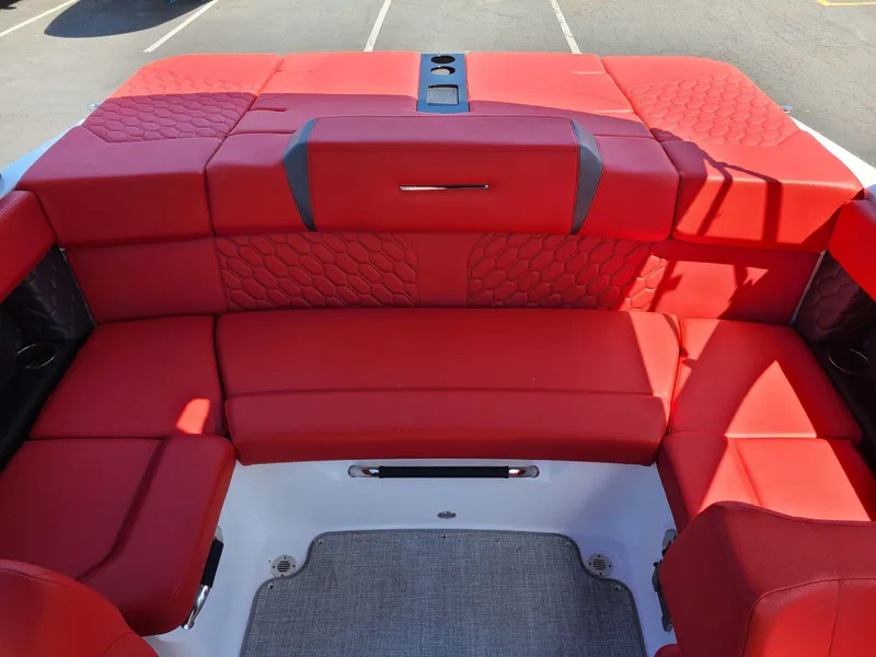 Slide: The Image of Red seating area of 2023 Four Winns H2 Surf boat, featuring quilted upholstery. - 3
