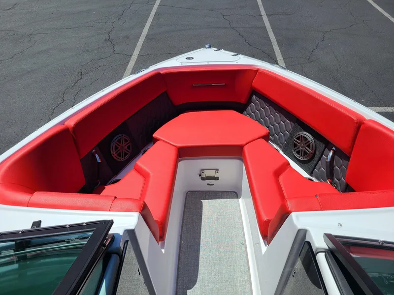 Slide: The Image of 2023 Four Winns H2 Surf boat with red seating and modern interior design. - 4