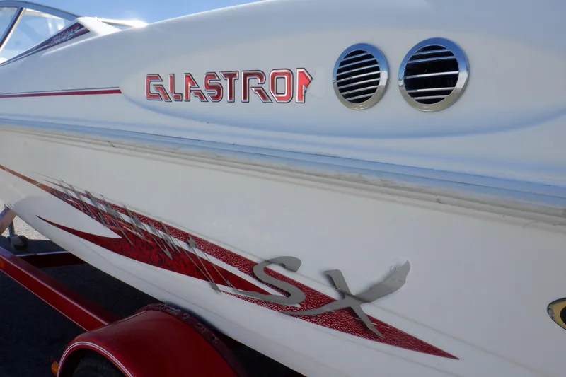 Slide: The Image of 2003 Glastron SX 195 boat side view with red graphics and logo. - 11