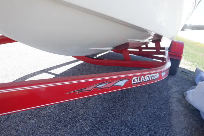 Slide: The Image of Red trailer for 2003 Glastron SX 195 boat on pavement. - 16