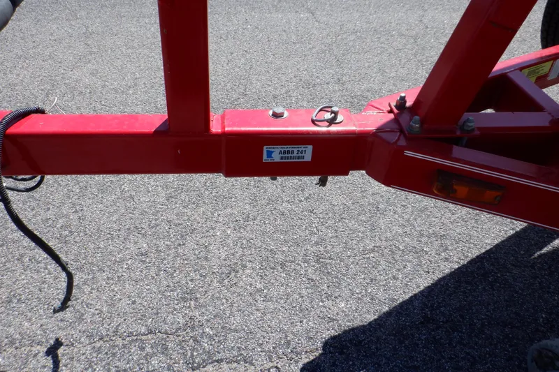 Slide: The Image of Red trailer hitch for 2003 Glastron SX 195 boat on asphalt surface. - 17