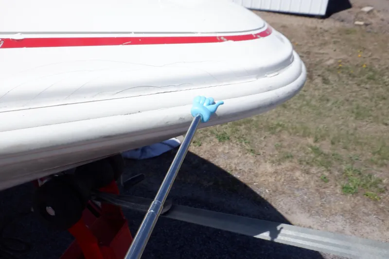 Slide: The Image of 2003 Glastron SX 195 boat with visible hull damage and a pointing tool. - 19