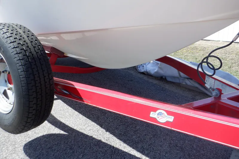 Slide: The Image of 2003 Glastron SX 195 boat on red trailer, close-up view. - 21