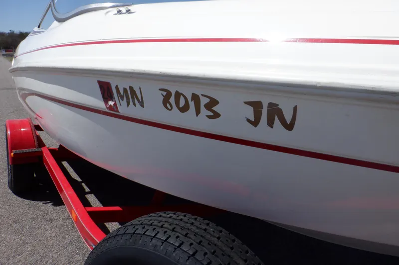 Slide: The Image of 2003 Glastron SX 195 boat with red trailer, side view showing registration number. - 22