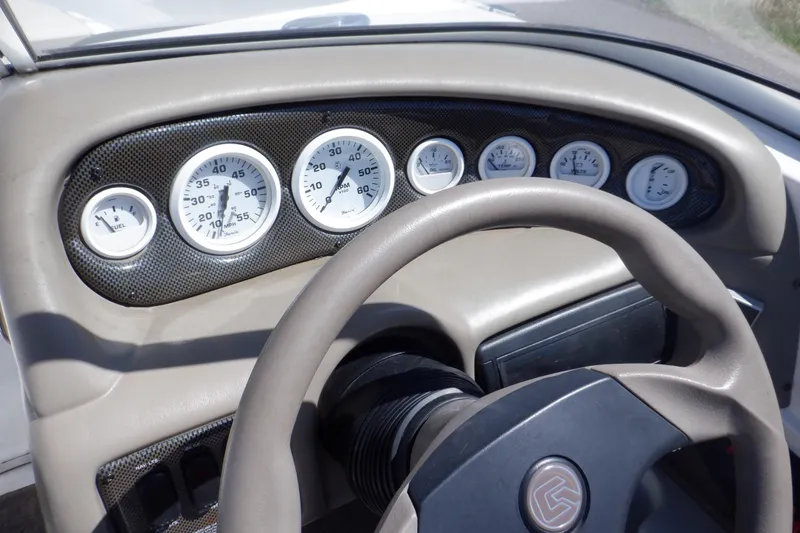 Slide: The Image of Dashboard of 2003 Glastron SX 195 boat with gauges and steering wheel. - 27