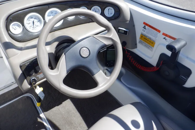 Slide: The Image of 2003 Glastron SX 195 boat dashboard with steering wheel and instrument panel. - 28