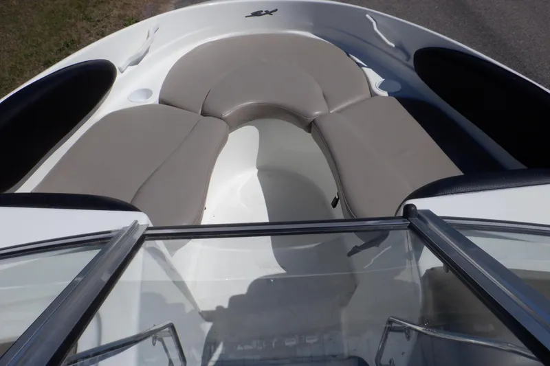Slide: The Image of 2003 Glastron SX 195 boat interior with beige seating and windshield view. - 30