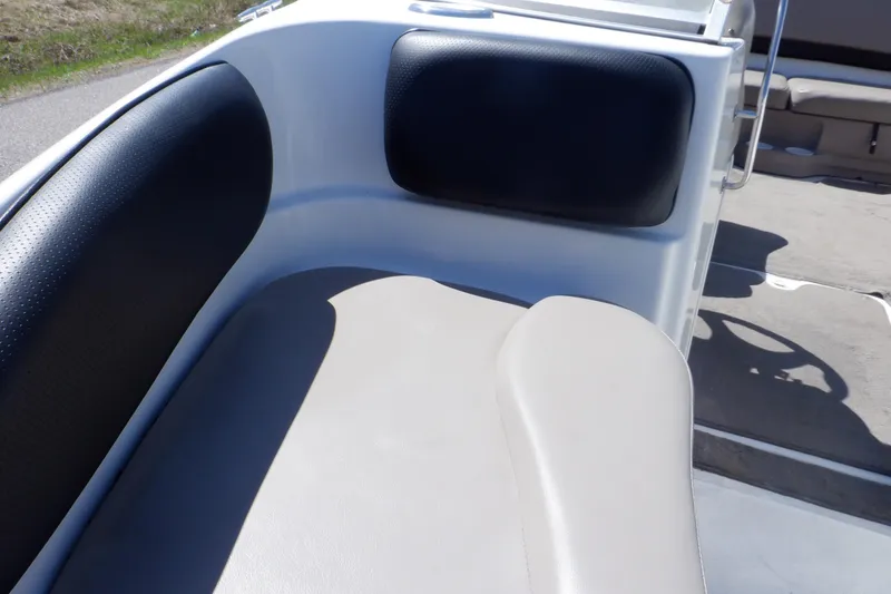 Slide: The Image of 2003 Glastron SX 195 boat interior seating with black and beige upholstery. - 33