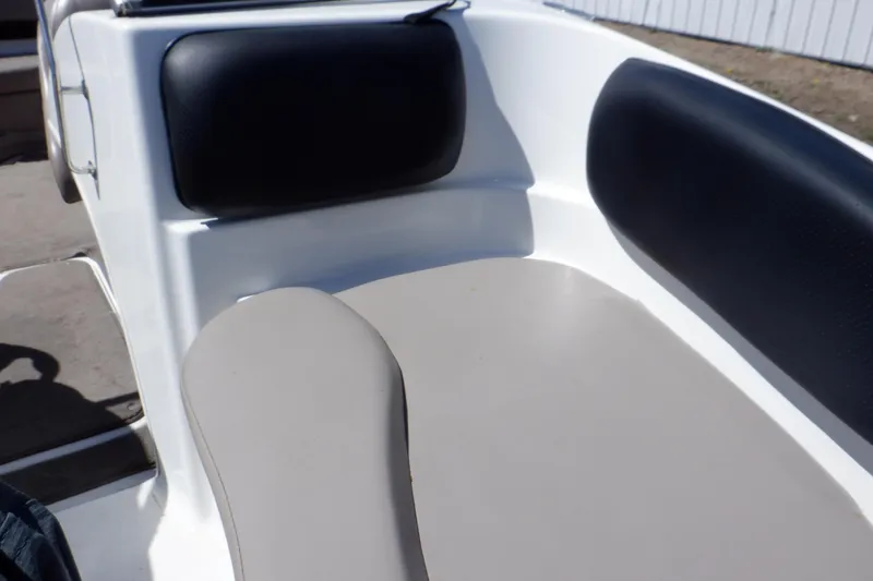 Slide: The Image of 2003 Glastron SX 195 boat interior with black and beige seating. - 34