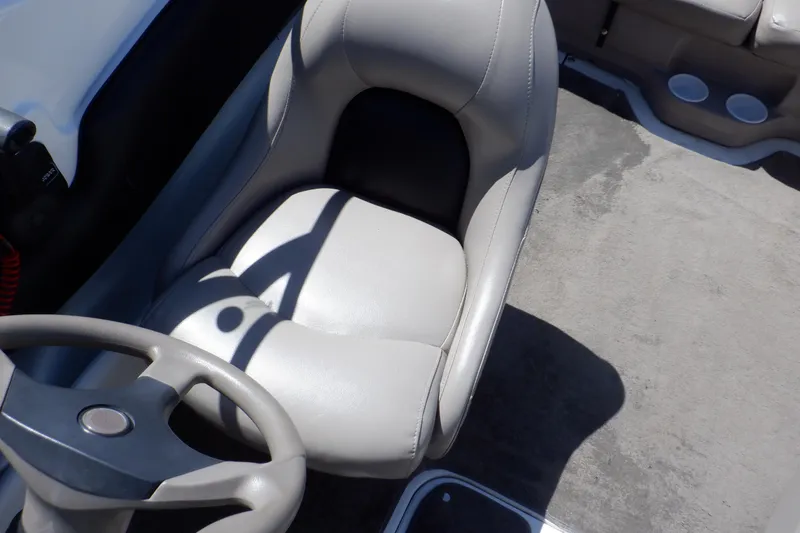 Slide: The Image of 2003 Glastron SX 195 boat interior with steering wheel and seat. - 37