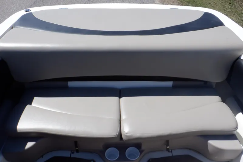 Slide: The Image of 2003 Glastron SX 195 boat interior seating with cup holders, featuring gray upholstery. - 38