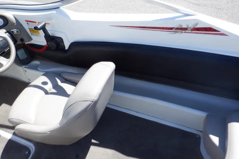 Slide: The Image of 2003 Glastron SX 195 boat interior with white seating and dashboard controls. - 42