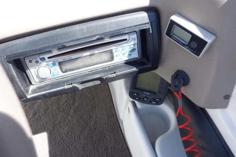 Slide: The Image of 2003 Glastron SX 195 dashboard with stereo system and electronic display. - 44