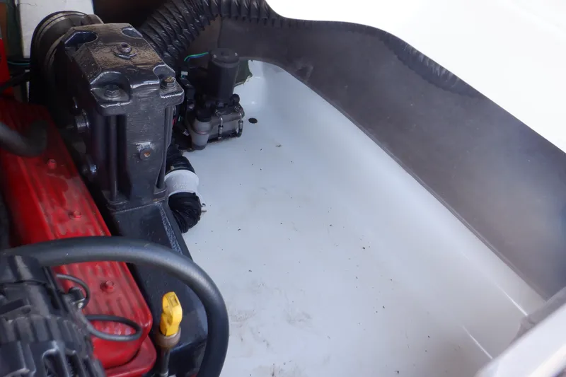 Slide: The Image of Engine compartment of a 2003 Glastron SX 195 boat, showcasing mechanical components. - 47