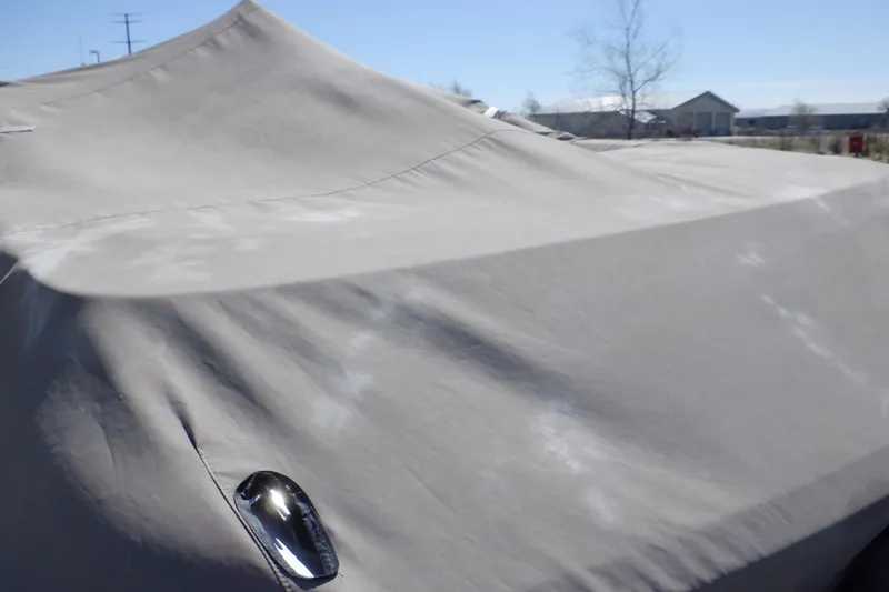 Slide: The Image of Covered 2003 Glastron SX 195 boat with protective tarp outdoors. - 50