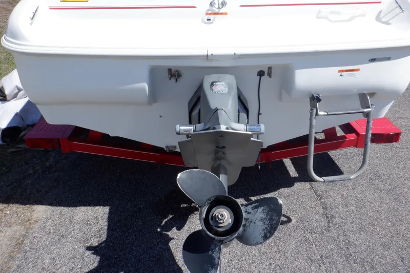 Slide: The Image of Rear view of 2003 Glastron SX 195 boat with visible propeller and ladder. - 7