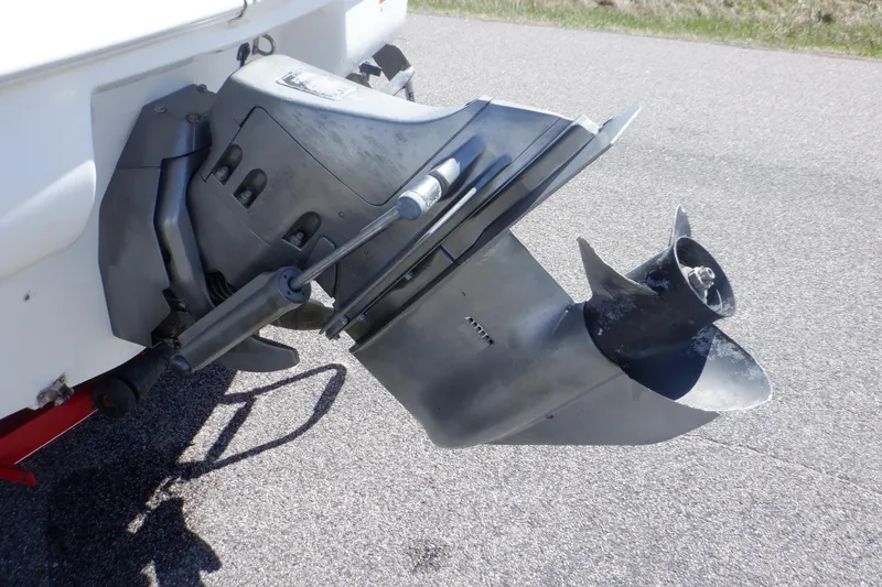 Slide: The Image of 2003 Glastron SX 195 boat outboard motor on pavement. - 8