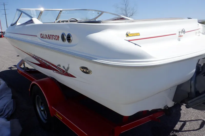 Slide: The Image of 2003 Glastron SX 195 boat on a red trailer, side view. - 9