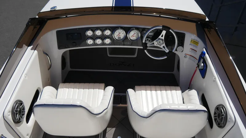Slide: The Image of 2022 Donzi 22 Classic boat interior with white seats and dashboard gauges. - 10