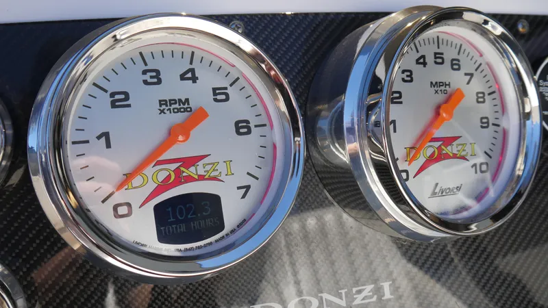 Slide: The Image of Dashboard gauges of a 2022 Donzi 22 Classic boat, showing RPM and MPH. - 15