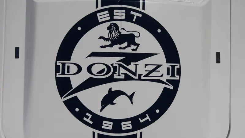 Slide: The Image of Logo of Donzi 22 Classic 2022 featuring a lion and dolphin, established 1964. - 16