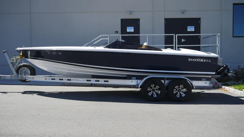 Slide: The Image of 2022 Donzi 22 Classic boat on trailer, parked outdoors. - 4