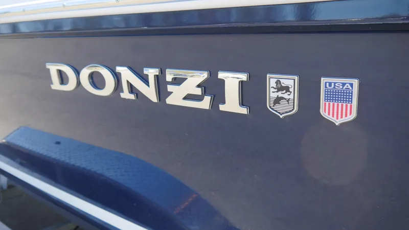 Slide: The Image of 2022 Donzi 22 Classic boat logo with USA emblem on dark blue hull. - 7