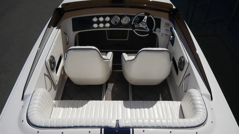 Slide: The Image of 2022 Donzi 22 Classic boat interior with white seating and dashboard gauges. - 9