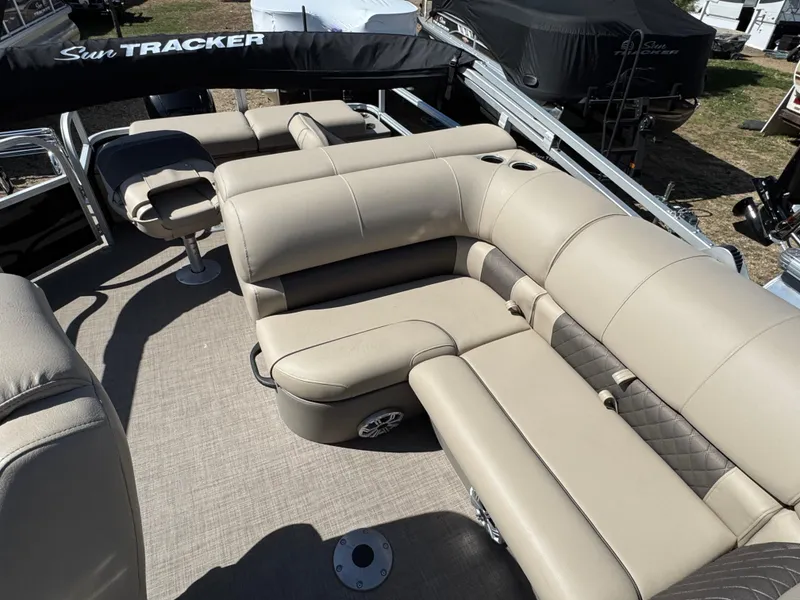 Slide: The Image of 2023 Sun Tracker SportFish 22 XP3 pontoon boat with beige seating and spacious layout. - 12